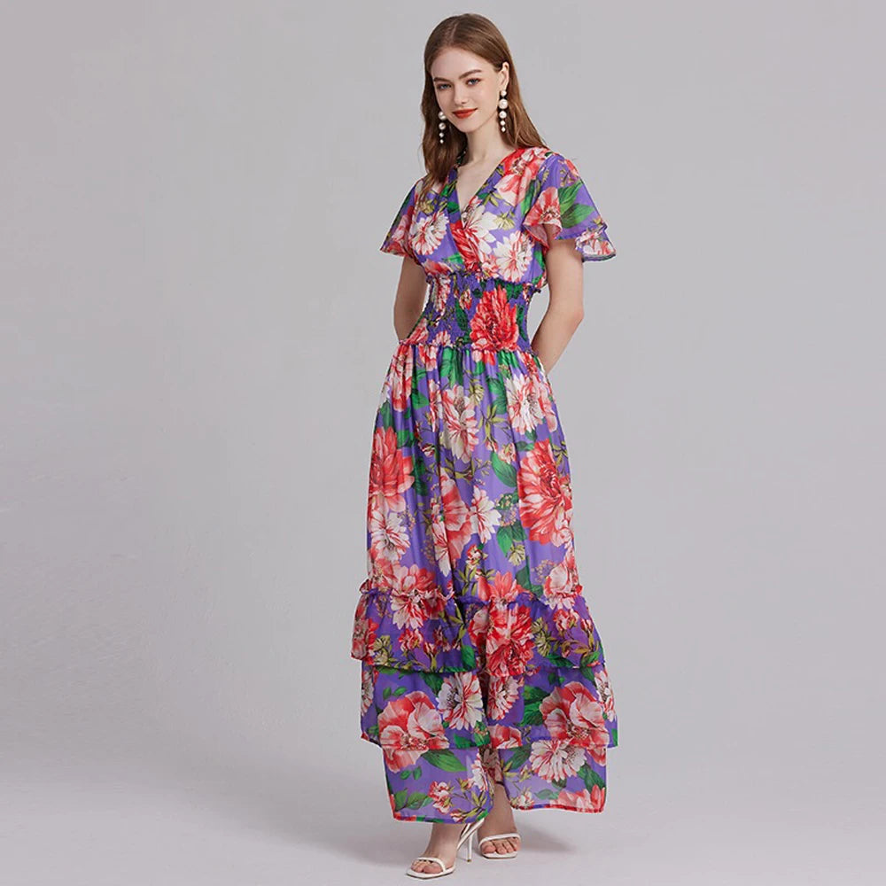 Introducing the Robe Aurora, the perfect summer dress for any occasion. Made with a beautiful floral pattern and a flattering v-neck design, this maxi dress also features an elastic waist for a comfortable fit and stylish ruffles. Stay cool and chic in this must-have piece.