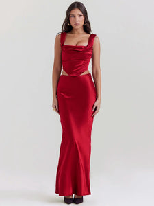 The Ensemble Pauline is perfect for any special occasion. Make a stunning entrance in this sleek two-piece set with a backless crop top and a long, elegant skirt. The sleeveless design and soft, luxurious fabric will keep you comfortable all night long. Shine on the dance floor and show off your best moves in this sexy skirt set.