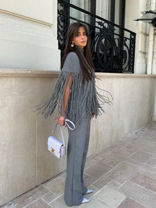 This elegant Fringed Knitted Cape is the perfect addition to any fashion-forward wardrobe. Crafted with a slim cut and tassel hem, the high neck and long fringe detail add an element of sophistication. Stay stylish and comfortable with this must-have piece for any occasion.