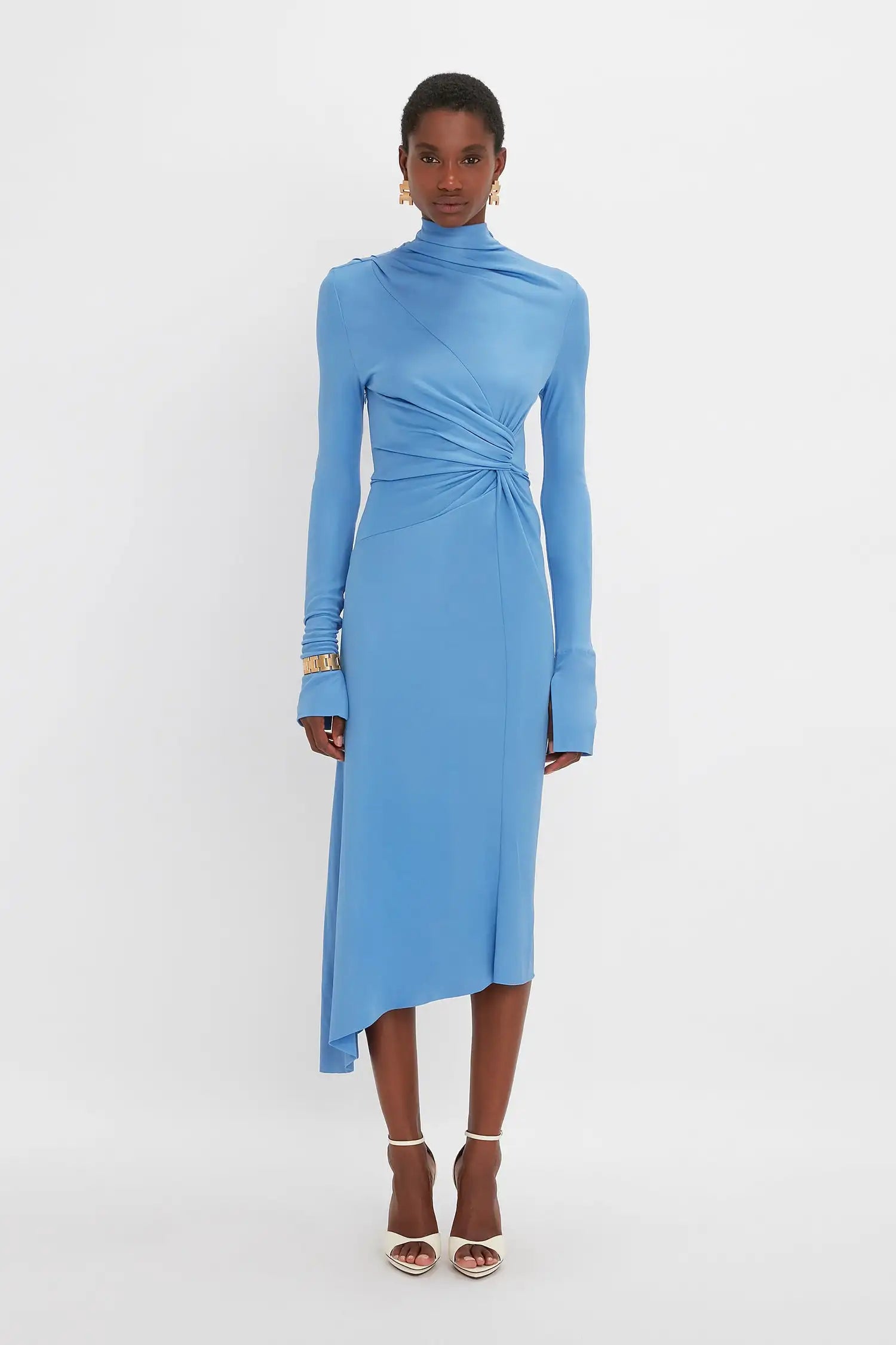 Experience luxury and sophistication with our Victoria Beckham asymmetric draped midi dress. Handmade by a high-end designer, this dress boasts a beautiful blue color and is crafted with the finest silk. Elevate your style with this stunning piece that exudes elegance and grace.