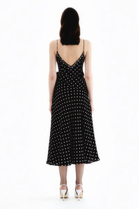 This high-quality designer slip dress, adorned with a playful polka dot print and finished with a delicate bow, is a top-of-the-line addition to any wardrobe. Handmade by industry experts, this Alessandra Rich dress offers a slinky, sophisticated silhouette perfect for any occasion.