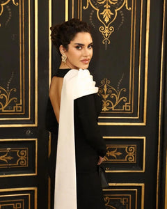 Introducing the Haley Gown, a stunning and exquisite piece that exudes luxury and sophistication. The long sleeves add a touch of elegance to the classic black satin, making it perfect for any formal occasion. With its alluring design, this gown is sure to turn heads and leave a lasting impression. Elevate your style with the Haley Gown.