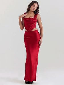 The Ensemble Pauline is perfect for any special occasion. Make a stunning entrance in this sleek two-piece set with a backless crop top and a long, elegant skirt. The sleeveless design and soft, luxurious fabric will keep you comfortable all night long. Shine on the dance floor and show off your best moves in this sexy skirt set.