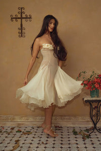 Crafted from delicate silk chiffon, the Valentina Dress in Butter features exquisite handcrafted floral appliqués precisely placed on the bust, creating a unique motif inspired by a weekly bouquet of roses. The 1/8-inch chiffon crisscross straps at the bust center add refined detail, while the dress includes a full separate lining, allowing for versatile styling options. A discreet center back zipper ensures a tailored fit, combining elegance with comfort for a sophisticated silhouette.