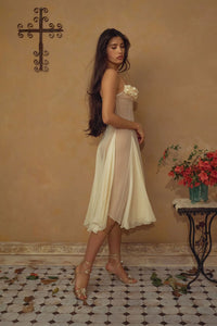 Crafted from delicate silk chiffon, the Valentina Dress in Butter features exquisite handcrafted floral appliqués precisely placed on the bust, creating a unique motif inspired by a weekly bouquet of roses. The 1/8-inch chiffon crisscross straps at the bust center add refined detail, while the dress includes a full separate lining, allowing for versatile styling options. A discreet center back zipper ensures a tailored fit, combining elegance with comfort for a sophisticated silhouette.