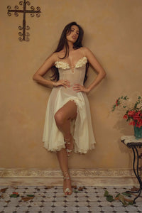 Crafted from delicate silk chiffon, the Valentina Dress in Butter features exquisite handcrafted floral appliqués precisely placed on the bust, creating a unique motif inspired by a weekly bouquet of roses. The 1/8-inch chiffon crisscross straps at the bust center add refined detail, while the dress includes a full separate lining, allowing for versatile styling options. A discreet center back zipper ensures a tailored fit, combining elegance with comfort for a sophisticated silhouette.
