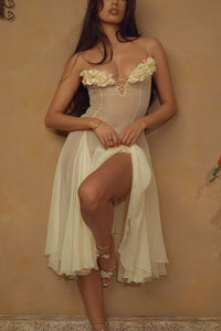 Crafted from delicate silk chiffon, the Valentina Dress in Butter features exquisite handcrafted floral appliqués precisely placed on the bust, creating a unique motif inspired by a weekly bouquet of roses. The 1/8-inch chiffon crisscross straps at the bust center add refined detail, while the dress includes a full separate lining, allowing for versatile styling options. A discreet center back zipper ensures a tailored fit, combining elegance with comfort for a sophisticated silhouette.