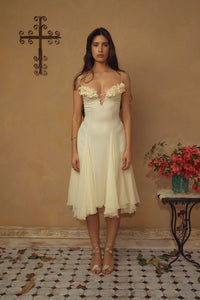 Crafted from delicate silk chiffon, the Valentina Dress in Butter features exquisite handcrafted floral appliqués precisely placed on the bust, creating a unique motif inspired by a weekly bouquet of roses. The 1/8-inch chiffon crisscross straps at the bust center add refined detail, while the dress includes a full separate lining, allowing for versatile styling options. A discreet center back zipper ensures a tailored fit, combining elegance with comfort for a sophisticated silhouette.