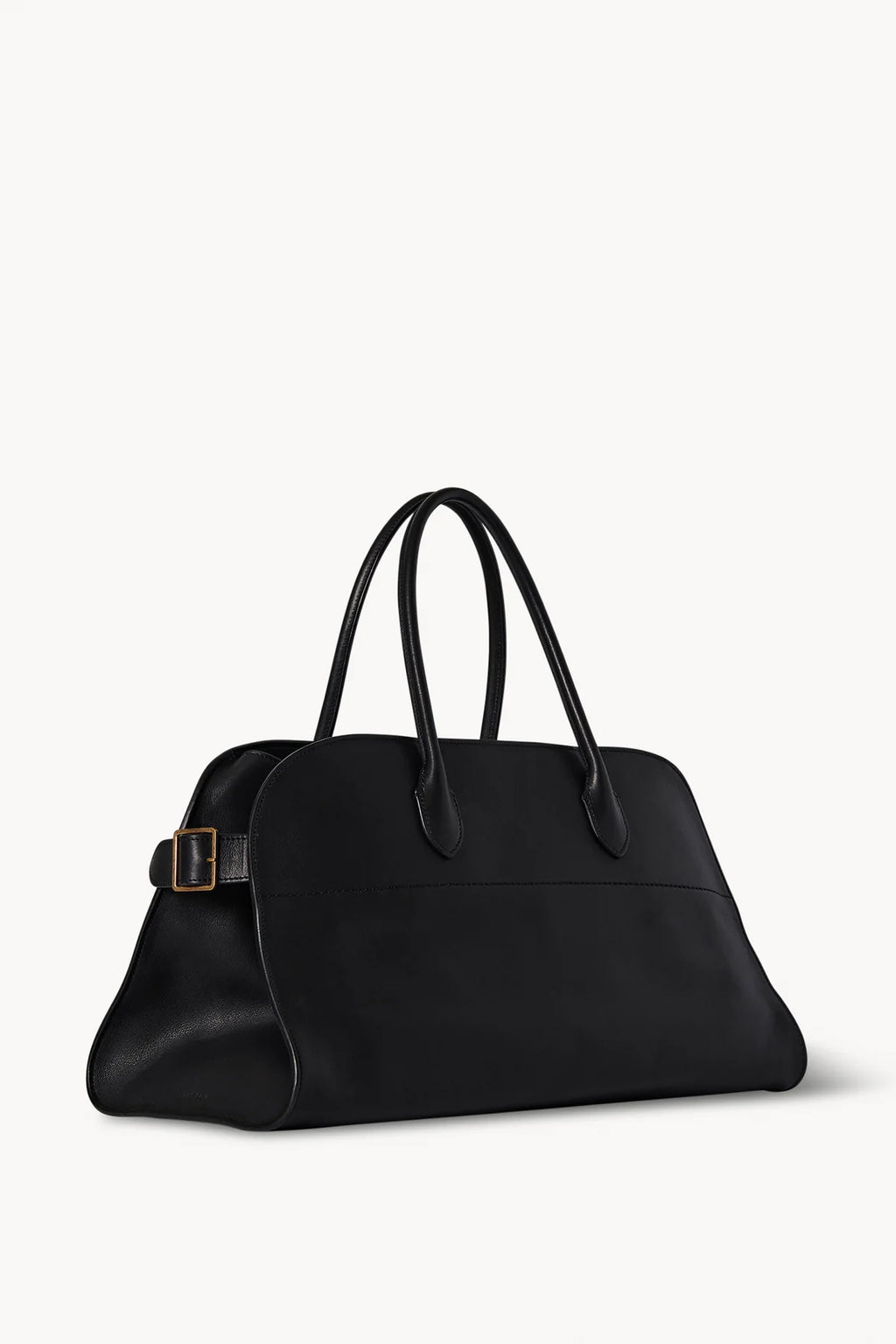 Structured top-handle bag in smooth saddle leather with signature belted side panels and subtly narrowed shape for shoulder wear.