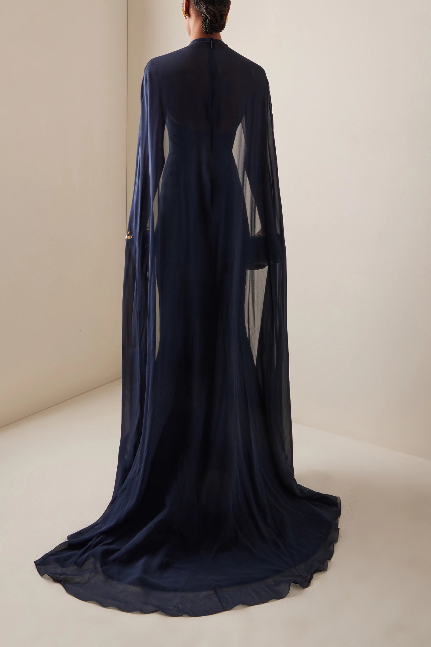 The silk blend long dress by Elie Saab features a non-detachable sheer cape that adds an elegant touch to your look. The beautiful flower appliqués at the neckline give this dress a unique and feminine vibe, perfect for that special occasion. Made of a high-quality silk in a flattering navy color, this dress is available in a range of sizes to suit every body type.