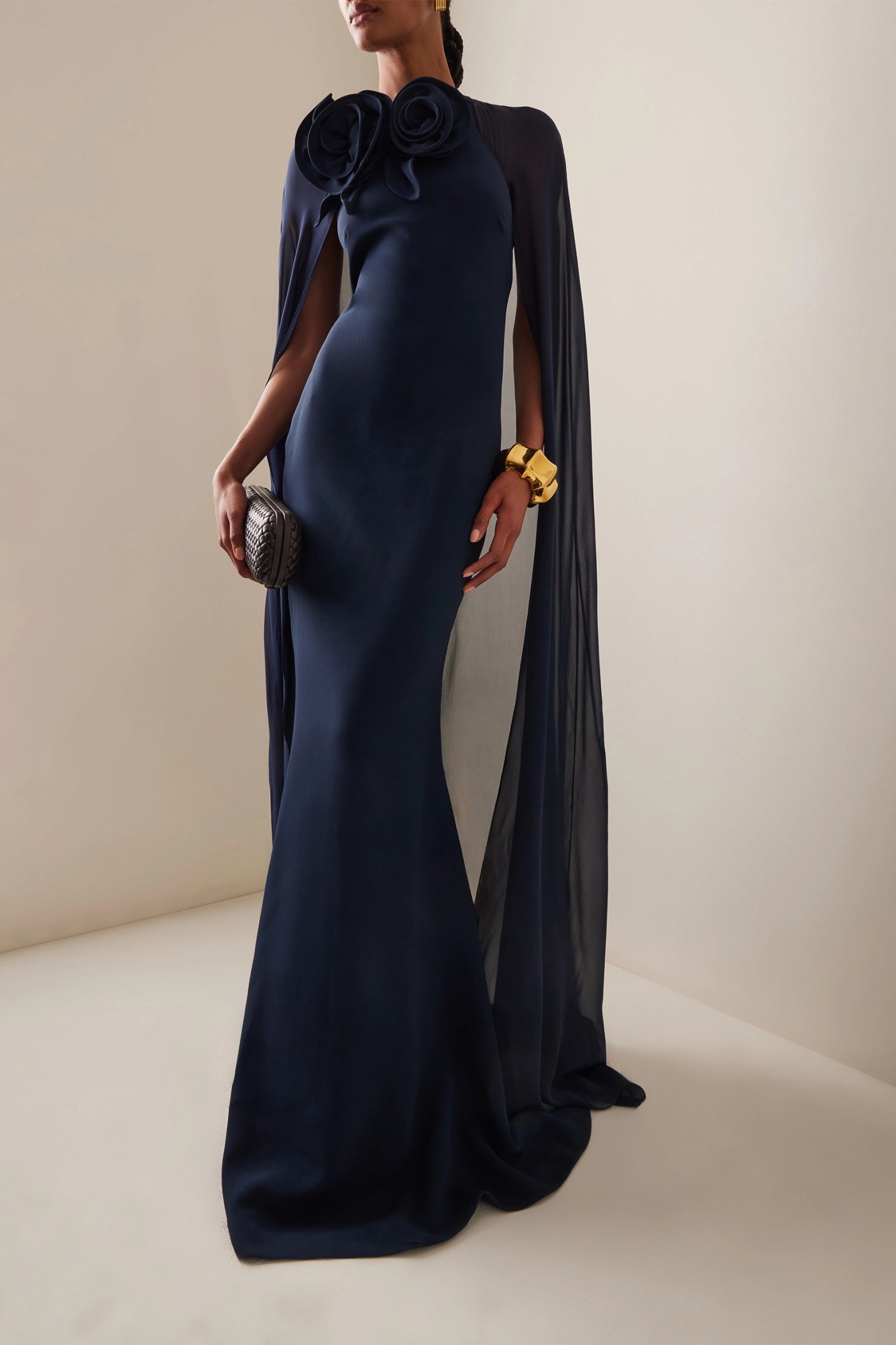 The silk blend long dress by Elie Saab features a non-detachable sheer cape that adds an elegant touch to your look. The beautiful flower appliqués at the neckline give this dress a unique and feminine vibe, perfect for that special occasion. Made of a high-quality silk in a flattering navy color, this dress is available in a range of sizes to suit every body type.