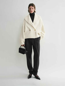 Elevate your layering with this oversized shawl-lapel cardigan by Toteme. Crafted from soft ribbed wool, it offers warmth and cozy comfort while its wide armholes and sleeves ensure effortless movement. The crossed front with button fastening adds a stylish, secure fit, and the curved shawl lapels bring a sophisticated touch to any outfit. Perfect for chic, relaxed days or cozy evenings indoors.