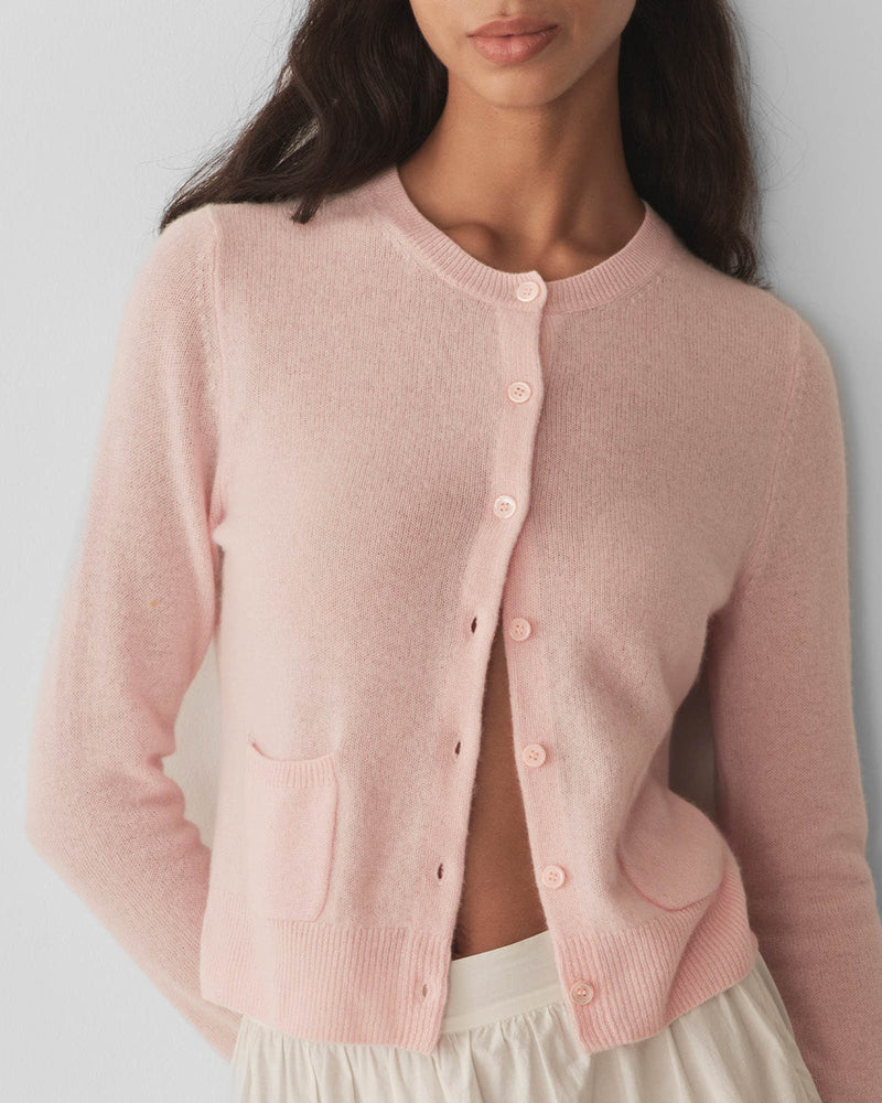 Embrace timeless elegance with the Freya Cardigan by Doen, a luxurious piece that channels 1960s sophistication. Crafted from sumptuous 100% cashmere, this fitted cardigan features a classic crew neck and bracelet-length sleeves that flatter every frame. Mother-of-pearl buttons add an understated touch of refinement, while the tailored silhouette ensures effortless polish for any occasion. 