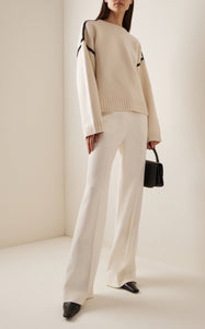 Embrace effortless Scandinavian style with this white wool-cashmere sweater by Totême. Crafted in a wide silhouette from mid-weight wool blended with cashmere, it offers cozy warmth and a soft touch. Intricate contrasting embroidery along the shoulders and armholes adds a refined, artisanal detail, elevating your everyday knitwear with subtle sophistication. Perfect for those who appreciate modern minimalism infused with a unique, handcrafted feel.