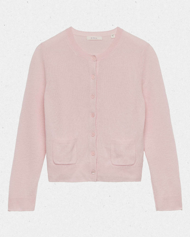 Embrace timeless elegance with the Freya Cardigan by Doen, a luxurious piece that channels 1960s sophistication. Crafted from sumptuous 100% cashmere, this fitted cardigan features a classic crew neck and bracelet-length sleeves that flatter every frame. Mother-of-pearl buttons add an understated touch of refinement, while the tailored silhouette ensures effortless polish for any occasion. 