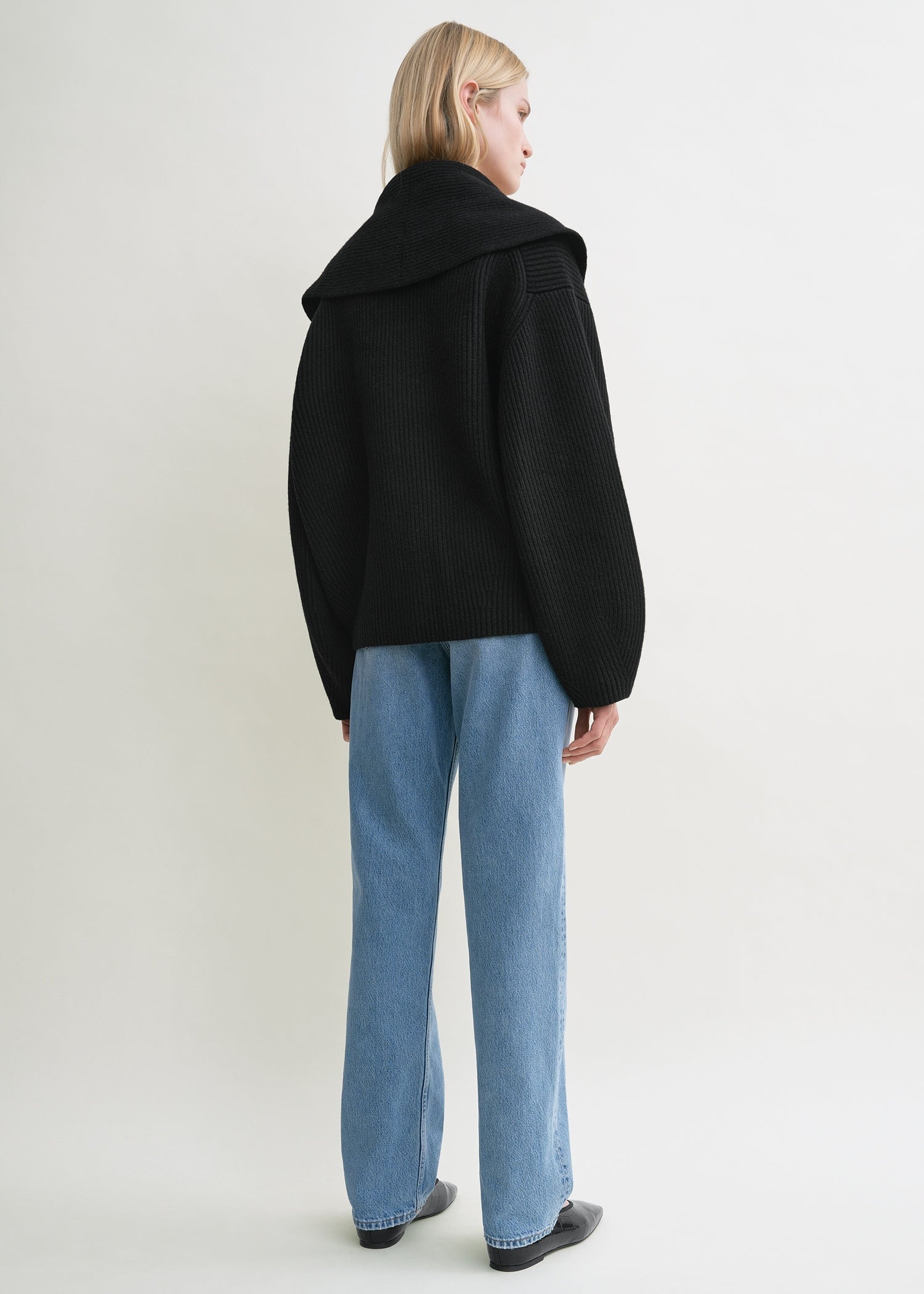 Elevate your layering with this oversized shawl-lapel cardigan in black by Toteme. Crafted from soft ribbed wool, it offers warmth and cozy comfort while its wide armholes and sleeves ensure effortless movement. The crossed front with button fastening adds a stylish, secure fit, and the curved shawl lapels bring a sophisticated touch to any outfit. Perfect for chic, relaxed days or cozy evenings indoors.