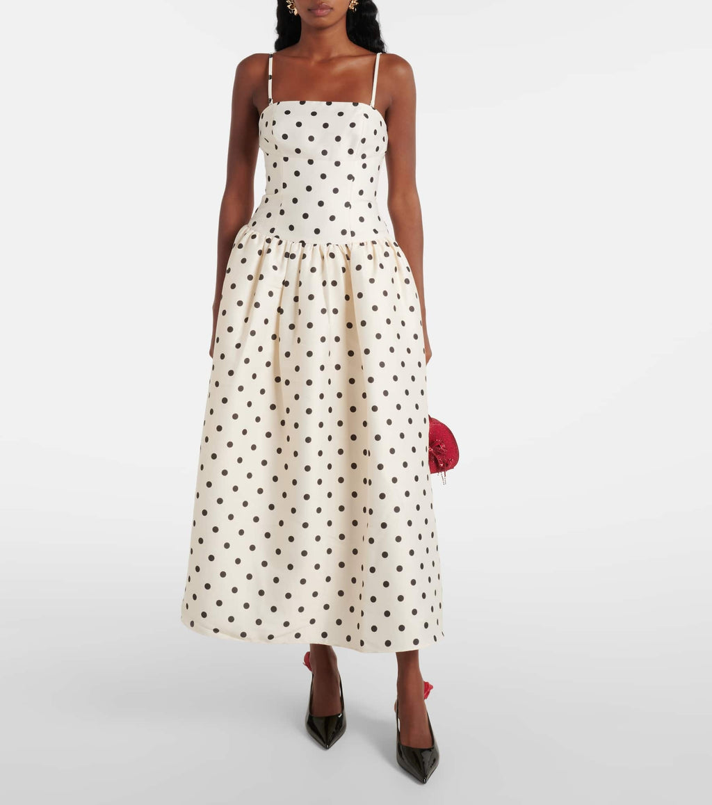 Embody timeless elegance with the Polka-dot taffeta corset dress, inspired by the refined silhouettes of the 1950s. Crafted from lustrous taffeta adorned with a delicate polka-dot motif, this dress features a structured bodice and a carefully gathered waist that accentuates a graceful silhouette. The voluminous skirt enhances movement, creating a sophisticated statement suitable for any distinguished occasion. 