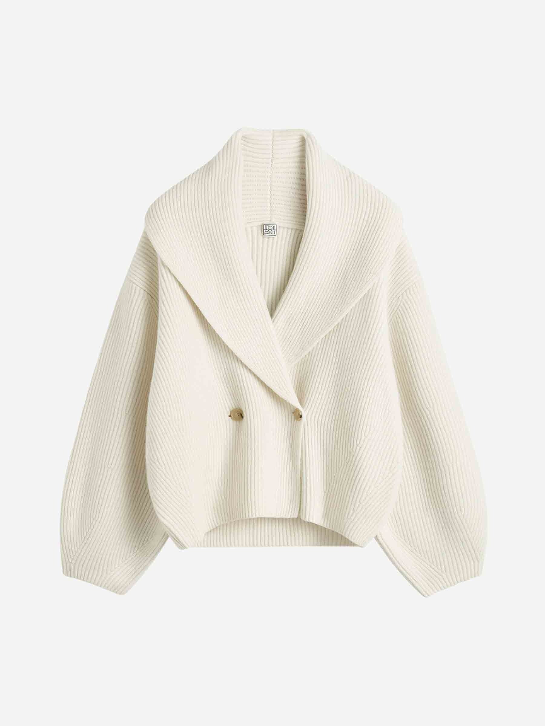 Elevate your layering with this oversized shawl-lapel cardigan by Toteme. Crafted from soft ribbed wool, it offers warmth and cozy comfort while its wide armholes and sleeves ensure effortless movement. The crossed front with button fastening adds a stylish, secure fit, and the curved shawl lapels bring a sophisticated touch to any outfit. Perfect for chic, relaxed days or cozy evenings indoors.