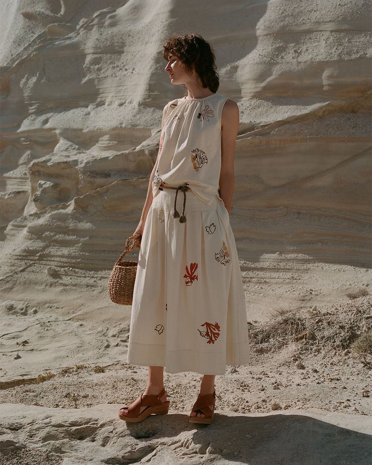 Look stylish and stay comfortable this summer with the Coral Embroidered Set. The loose drawstring vest, featuring retro embroidery, is perfect for hot days. Made from 100% cotton, the high waist skirt is both comfortable and stylish. Upgrade your wardrobe with this must-have set.