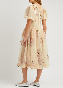 This floral-embroidered tulle midi dress by Simone Rocha embodies romance and elegance with its delicate sheer fabric and calf-length silhouette. Satin bows at the shoulders add a touch of refinement, while intricate floral embroidery, ruffled trims, and ruched details create a captivating, feminine look. Its flowing, loose skirt offers graceful movement, making it perfect for any special occasion where you want to stand out with timeless charm.