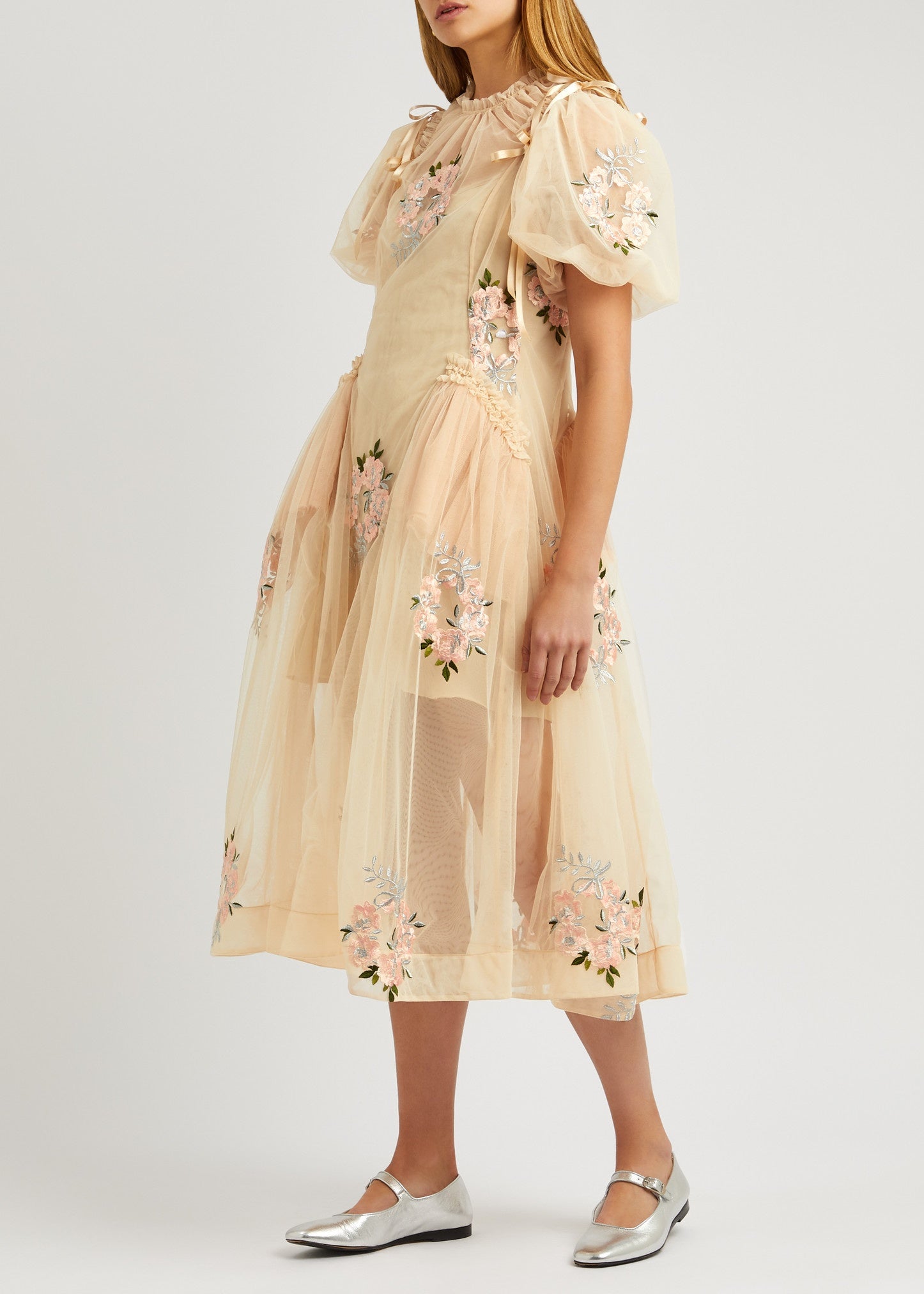 This floral-embroidered tulle midi dress by Simone Rocha embodies romance and elegance with its delicate sheer fabric and calf-length silhouette. Satin bows at the shoulders add a touch of refinement, while intricate floral embroidery, ruffled trims, and ruched details create a captivating, feminine look. Its flowing, loose skirt offers graceful movement, making it perfect for any special occasion where you want to stand out with timeless charm.