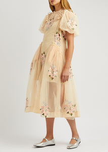 This floral-embroidered tulle midi dress by Simone Rocha embodies romance and elegance with its delicate sheer fabric and calf-length silhouette. Satin bows at the shoulders add a touch of refinement, while intricate floral embroidery, ruffled trims, and ruched details create a captivating, feminine look. Its flowing, loose skirt offers graceful movement, making it perfect for any special occasion where you want to stand out with timeless charm.