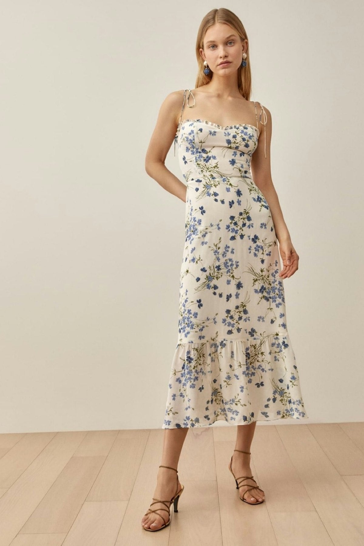 The Enya is a midi length dress with a sweetheart neckline. A smocked back bodice and tie straps with a fitted waist and a full skirt! Very easy to wear and comfortable!!