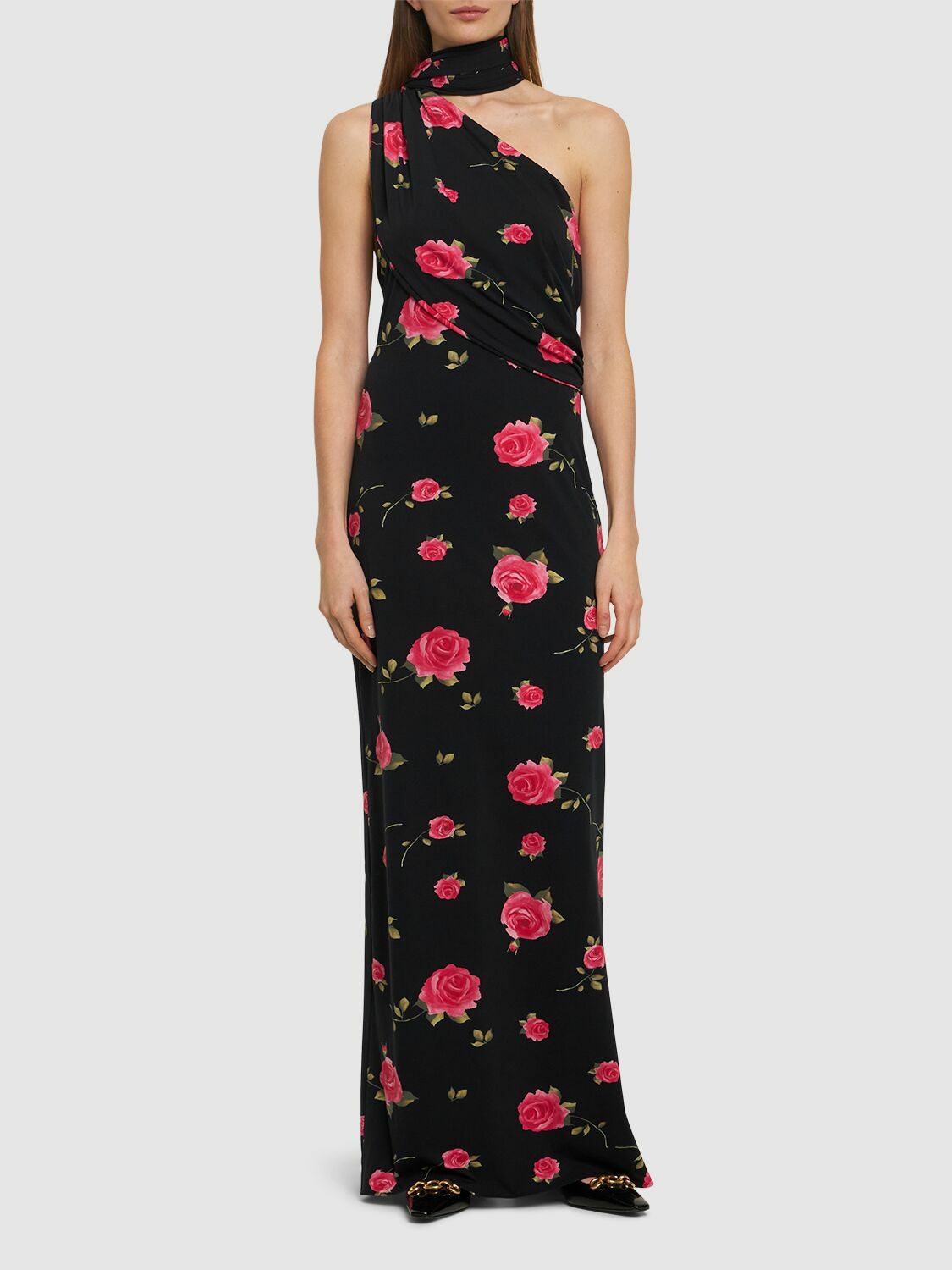 Introducing the luxurious Rose Print Jersey Long Dress by Magda Butrym. This stunning dress features a back zip closure and center back slit for ease of wear and a flattering silhouette. The non-detachable scarf panel adds a touch of elegance and the all over print placement may vary, making each dress unique. Elevate your wardrobe with this must-have piece.