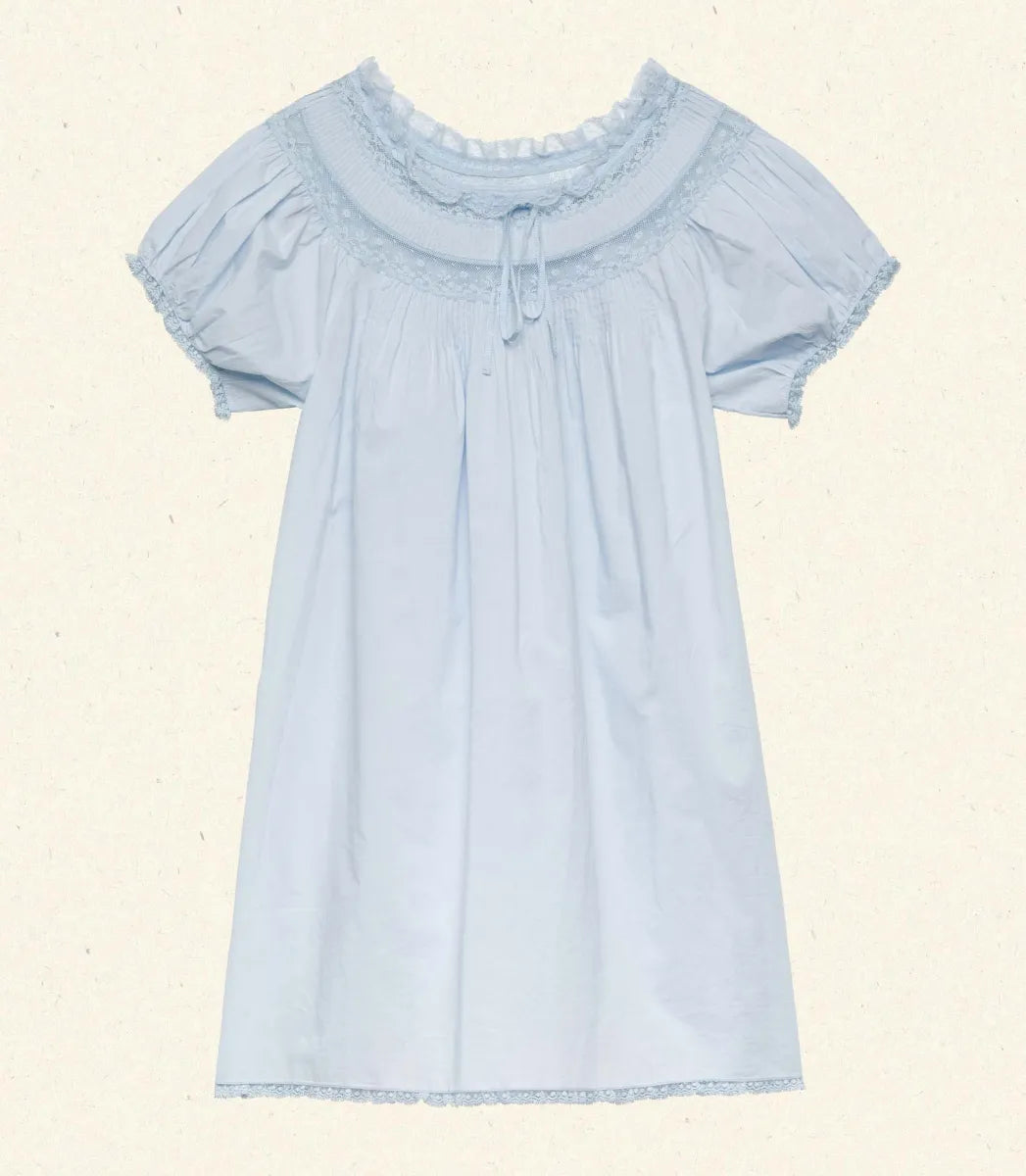 The Daphne Dress by Doen combines refined craftsmanship with effortless style, made from crisp organic cotton poplin for breathability and comfort. Its A-line silhouette and mini-length hem create a light, playful shape, while short puffed sleeves add subtle volume. Detailed with floral scallop lace, delicate pintucks, and a grosgrain ribbon tie at the yoke, this dress is completed with lace trims on the cuffs and hem. Ideal for warm weather occasions, it balances casual ease with elegant detailing.