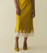 Load image into Gallery viewer, Get ready to embrace your inner risk-taker with the Elowen Skirt by Doen! This &#39;90s inspired garment-washed silk satin dress features a high-waisted design and delicate scallop elastic for a flattering fit. The bias-cut skirt falls gracefully to mid-calf, adorned with intricate contrast lace trim. Perfect for channeling vintage vibes or making a statement at any occasion!
