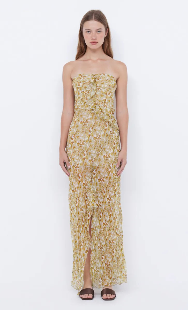 Elevate your style with the Opal Strapless Maxi Dress from bec + bridge. The lightweight, lustrous print fabric effortlessly drapes over your body, while the front leg split and asymmetrical raw cut ruffle detailing add a touch of sophistication. With a chic hanky drape hemline and versatile strapless neckline, this dress is perfect for any occasion. Add it to your wardrobe for an exclusive and timeless look.