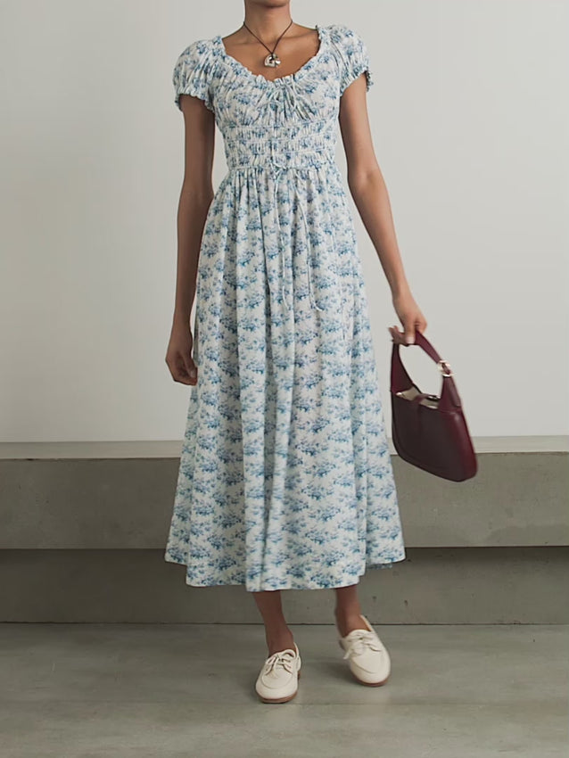 Experience effortless romance with the Ashlynn midi dress by DÔEN. Crafted from breathable organic cotton-voile, its all-over floral print captures a timeless, delicate charm. The shirred bodice offers a comfortable fit, while adjustable ties at the neckline and waist allow you to tailor the silhouette to your liking. Perfect for warm days and graceful evenings, this dress brings Southern Californian ease to your wardrobe with eco-friendly elegance.