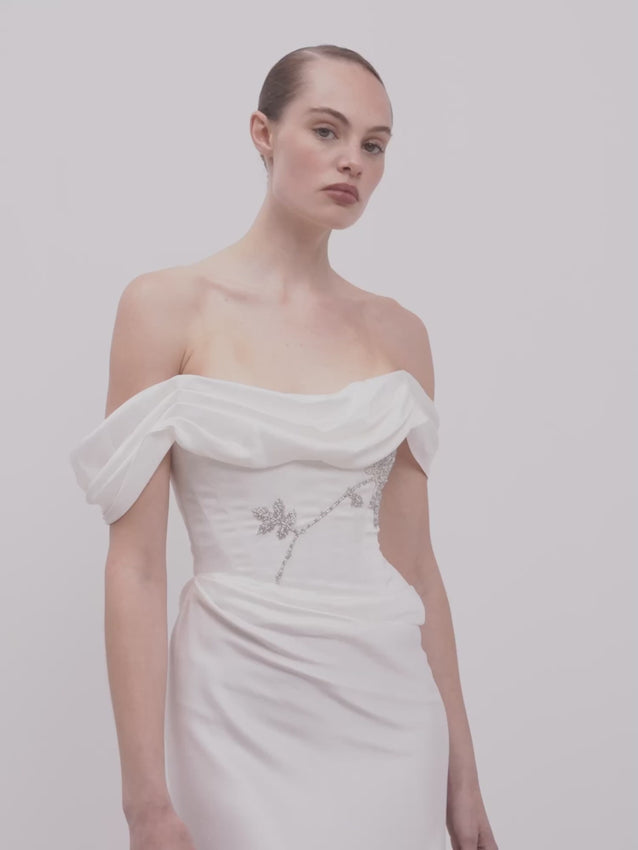 The Paloma Dress is a full-length gown that captures understated elegance through thoughtful design. Its sculpted corset bodice offers refined support, while the draped satin skirt flows with natural grace. This piece merges timeless couture craftsmanship with modern sophistication, making it an ideal choice for galas, milestone celebrations, and occasions calling for polished femininity. A dress designed to move beautifully and feel as luxurious as it looks.