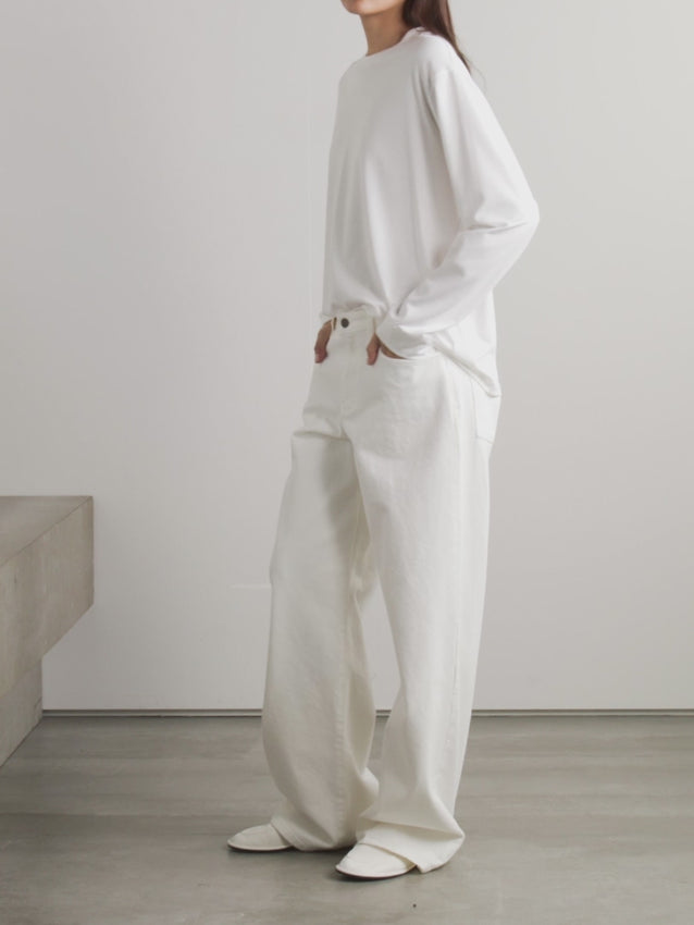 Crafted from premium cotton-jersey, the Ciles T-shirt embodies The Row's philosophy of timeless design and exceptional quality. Its relaxed silhouette offers effortless versatility—pair it with tailored trousers for polished sophistication, tuck it into denim for casual elegance, or layer it under midi skirts for refined dimension. 