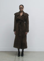 Load and play video in Gallery viewer, Elevate your wardrobe with the Brown Suede Trench Coat from Desavary London. Crafted with luxurious suede, this double breasted coat boasts an oversized fit and structured shoulders for a look that exudes sophistication. The buckle waist belt and storm flap add practicality to this statement piece. A must-have for any fashion-forward individual.
