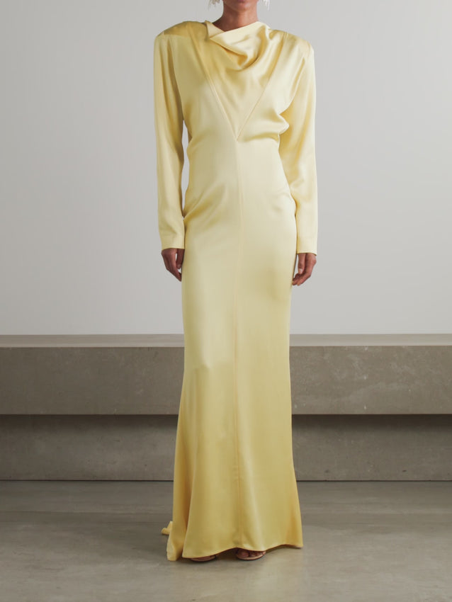 Elevate your evening with this striking Stella McCartney satin gown in luminous Camomille yellow. Crafted in Italy from luxurious satin, this unlined design features a modern uneven hem and a discreet zipped back closure. Customize your silhouette with detachable shoulder pads for added dimension. The sophisticated cut and fluid fabric create an effortlessly elegant statement piece perfect for special occasions. Dry clean only to preserve the fabric's lustrous finish.