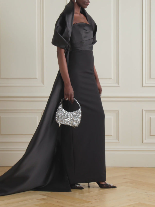 Elevate your evening with this stunning crepe gown from Solace London, where sophisticated elegance meets modern flair. The luxurious crepe fabric drapes beautifully, while delicate satin twill trim adds a touch of refined glamour. Perfect for galas, weddings, or any occasion that calls for show-stopping style. This timeless piece transitions seamlessly from red carpet to celebration, ensuring you feel confident and radiant all night long.