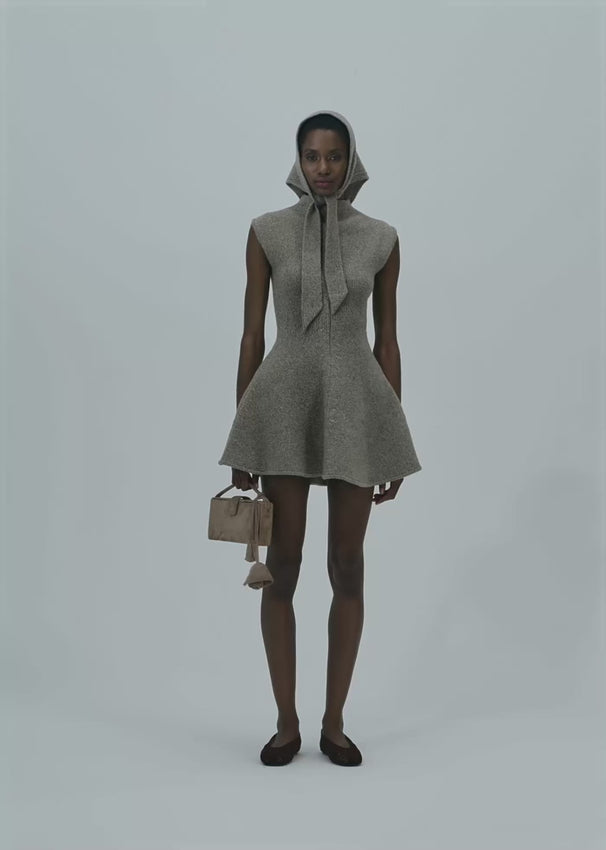 This marled knit skater dress offers a flattering flared skirt and sleeveless cut that accentuates the feminine silhouette. Crafted from soft knit fabric, it ensures lasting comfort throughout the day. Versatile and stylish, it seamlessly transitions from casual outings to more refined events, making it a practical yet elegant addition to any wardrobe.