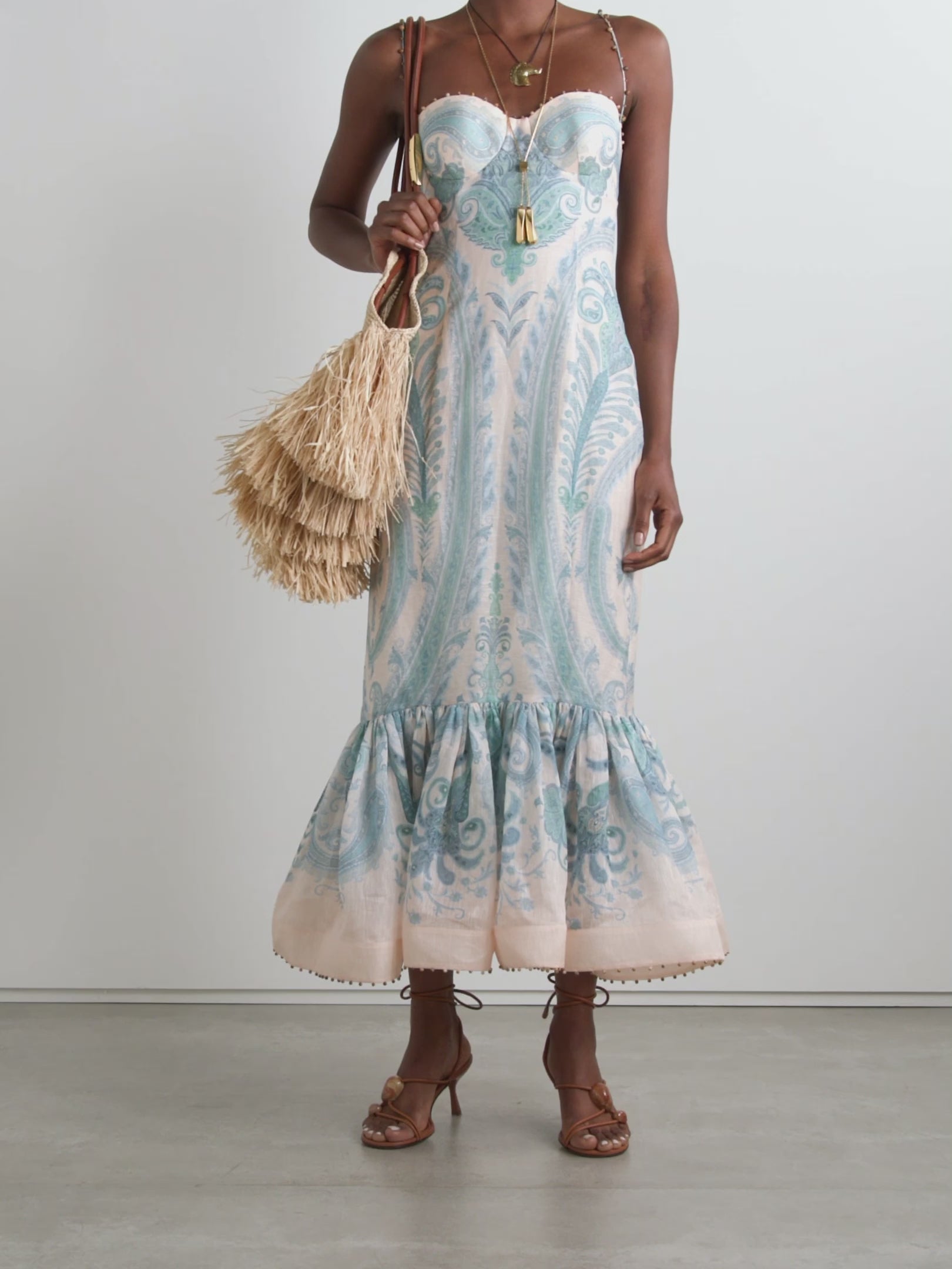 Elevate your elegance with Zimmermann's Illuminate gown, crafted from a luxurious linen and silk blend adorned with vibrant paisley swirls. This stunning dress features intricate bead embellishments along the sweetheart neckline, straps, and ruffled mermaid hem, adding a sparkling touch to your look. Designed with padded, underwired cups, it offers gentle support while enhancing your silhouette. 