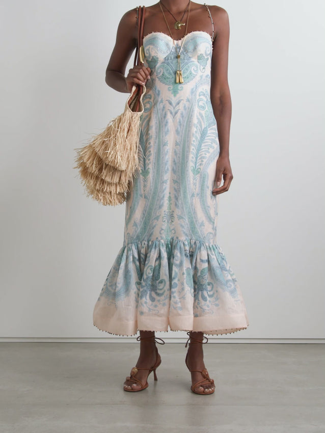 Elevate your elegance with Zimmermann's Illuminate gown, crafted from a luxurious linen and silk blend adorned with vibrant paisley swirls. This stunning dress features intricate bead embellishments along the sweetheart neckline, straps, and ruffled mermaid hem, adding a sparkling touch to your look. Designed with padded, underwired cups, it offers gentle support while enhancing your silhouette. 