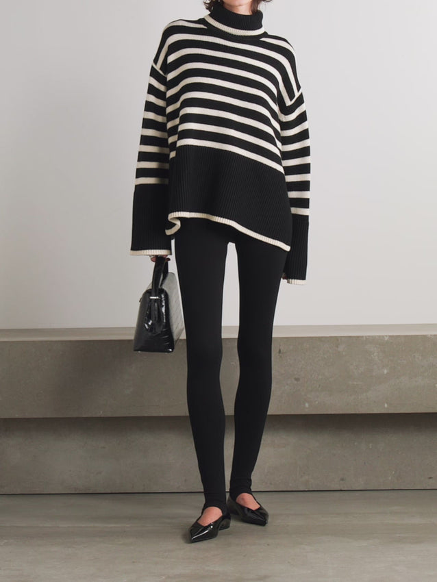 This striped wool-blend turtleneck sweater from TOTEME combines timeless style with cozy comfort. Crafted from a soft blend of wool and organic cotton, it features a relaxed fit and a classic turtleneck, making it perfect for layering. The iconic stripes add a refined touch, while the breathable fabric ensures warmth without bulk. Pair it with tailored pants for an effortlessly polished look that lasts season after season.