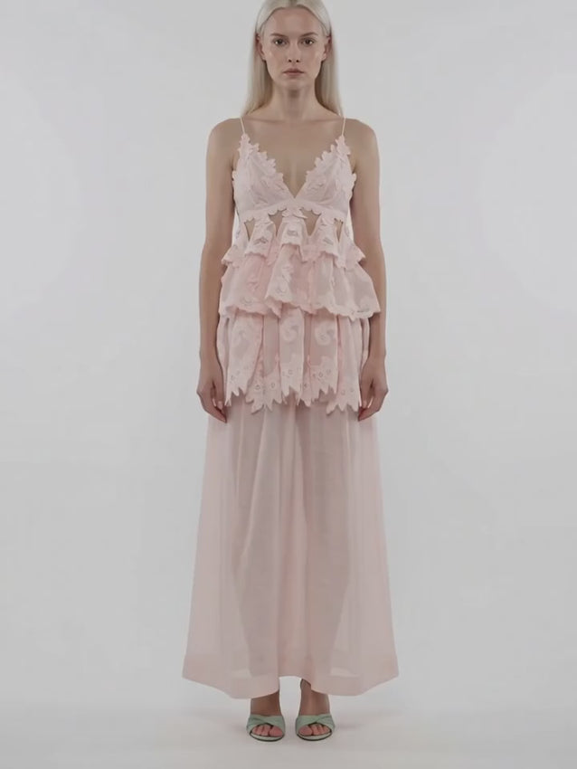 Ethereal light pink tiered lace maxi dress featuring a flattering V-neck and adjustable spaghetti straps for a customizable fit. The rear zip fastening pairs seamlessly with a rear clasp for secure closure and easy wear. Perfect for elegant occasions or romantic everyday styling.