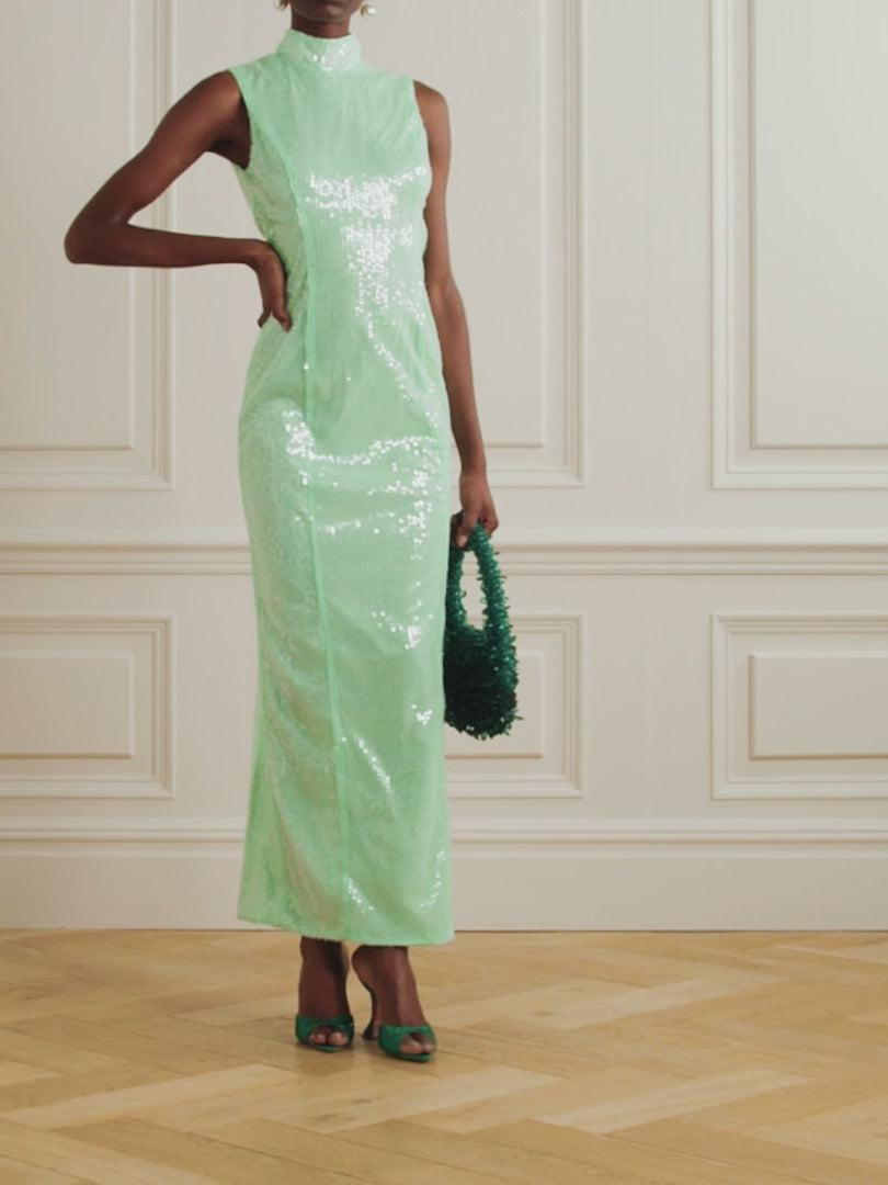 This maxi dress is perfect for any event. Its sequined fabric gives it a stunning shine, while its recycled-tulle material promotes sustainability. The high neckline and fluid silhouette add elegance, and the fresh mint shade adds a touch of uniqueness. Pair with drop earrings for a complete look.