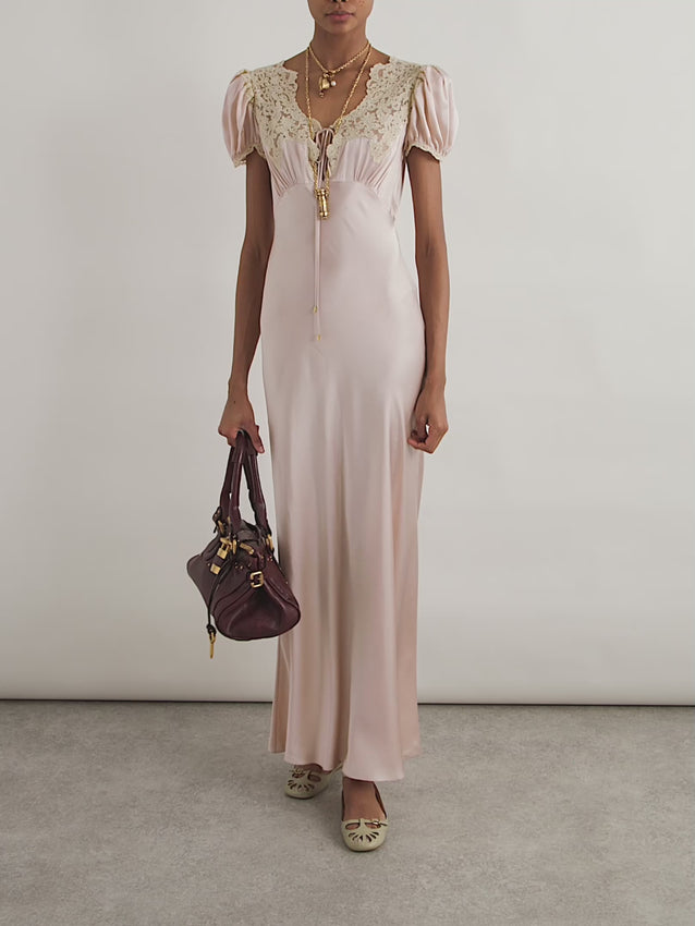Effortless elegance meets romantic charm in this washed silk satin maxi dress. Crafted from luxuriously soft fabric, it features a flattering scoop neckline adorned with delicate lace trim and a gathered keyhole detail at the chest. Self-tie fastening at both the chest and back allows for a customized fit, while voluminous puff sleeves add a touch of vintage-inspired sophistication. Lace trim at the cuffs completes the refined look. Perfect for special occasions or elevated everyday wear.