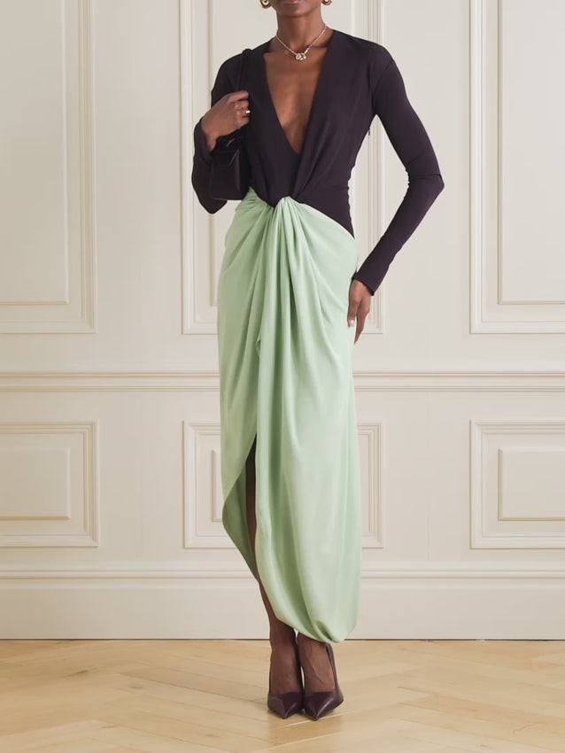 Slip into effortless elegance with this stunning two-tone jersey gown by Victoria Beckham, inspired by red-carpet glamour. The artful knot at the waist creates a flattering silhouette while the smooth fabric drapes beautifully. A plunging V-neckline, elongated cuffs, and a chic split hem add modern sophistication. Pair with point-toe mules for a look that's equal parts polished and playful—perfect for making a statement at any occasion.