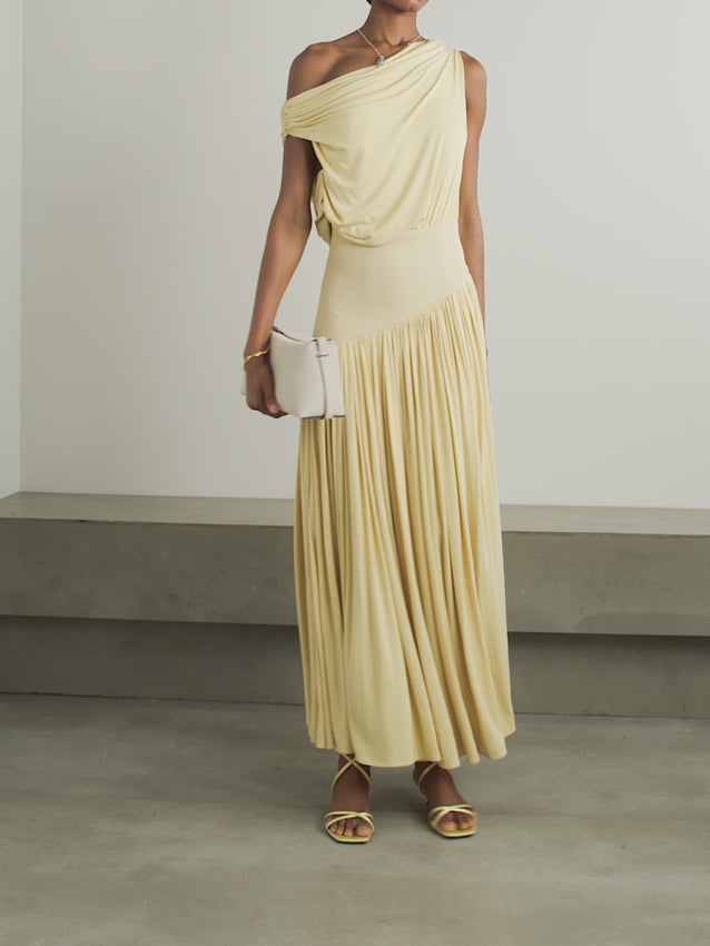 Discover effortless elegance with the Gwen Asymmetric Draped Jersey Dress by Abadia. Crafted from luxuriously soft stretch-bamboo fabric, this stunning piece features a sophisticated one-shoulder design that flatters every frame. Artfully draped details flow gracefully from the fitted top through the skirt, creating a silhouette that's both modern and timelessly chic. 