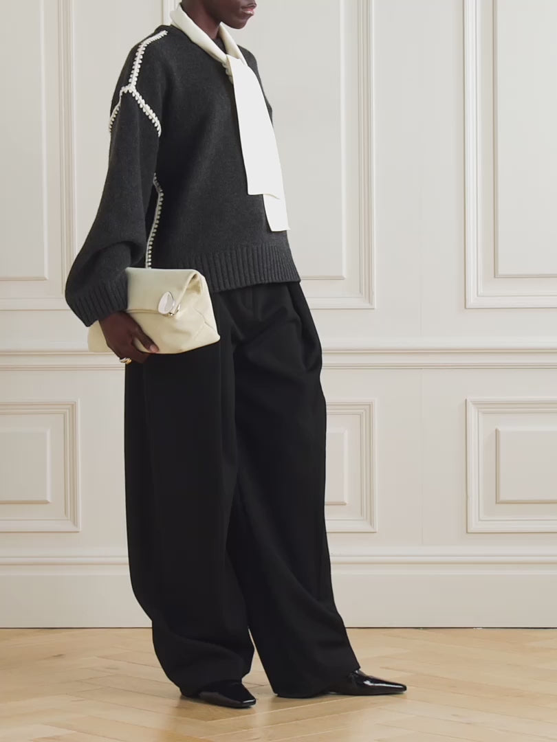 Elevate your wardrobe with this oversized sweater by Toteme crafted from a sumptuous wool and cashmere blend. Its relaxed fit with dropped shoulders offers effortless comfort, while the contrasting cream embroidery adds a refined, distinctive touch. Designed as a timeless staple, it seamlessly enriches your collection, providing both warmth and style for any occasion.