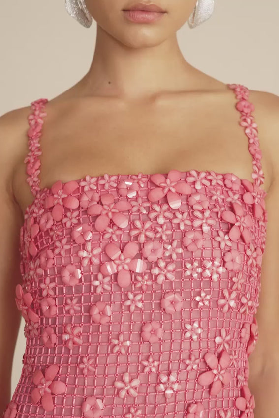 Discover timeless elegance with the Florabelle Dress in Strawberry. This delicate mini dress showcases intricate beaded floral appliqués layered over a sheer grid overlay, creating a romantic and sophisticated silhouette. Designed with spaghetti straps for a graceful drape, this piece is perfect for special occasions or elevated everyday styling. The combination of detailed beadwork and sheer fabric adds dimension and movement to your wardrobe.