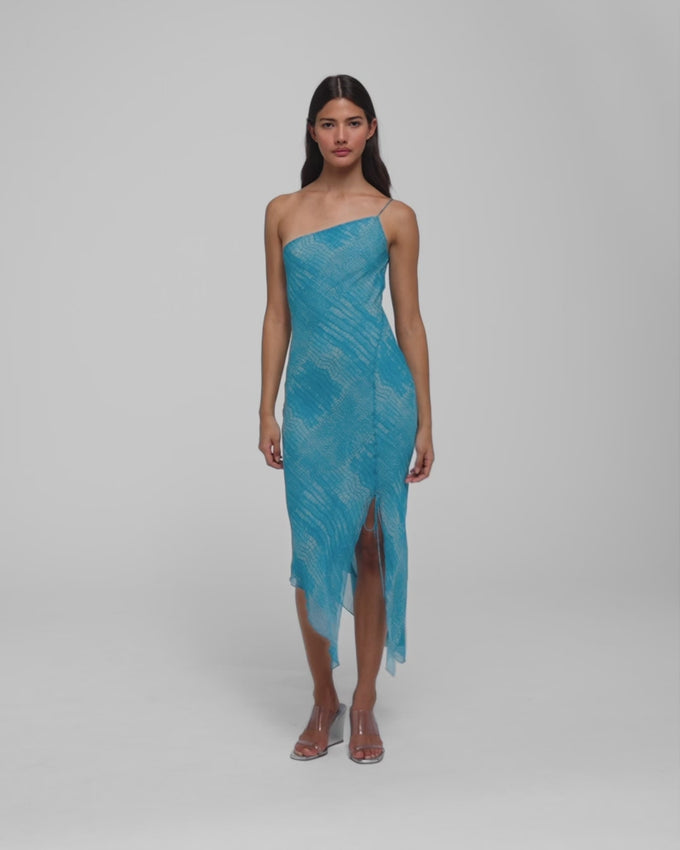 The Alberta dress captures the essence of effortless elegance with its striking sea blue snakeskin print and fluid silhouette. Cut on the bias, this asymmetric midi molds beautifully to your curves while the self-tie shoulder detail adds an unexpected touch of drama. A slit opening on the left leg and delicate lettuce hem create movement and dimension, while the non-sheer fabric ensures confidence with every wear. 