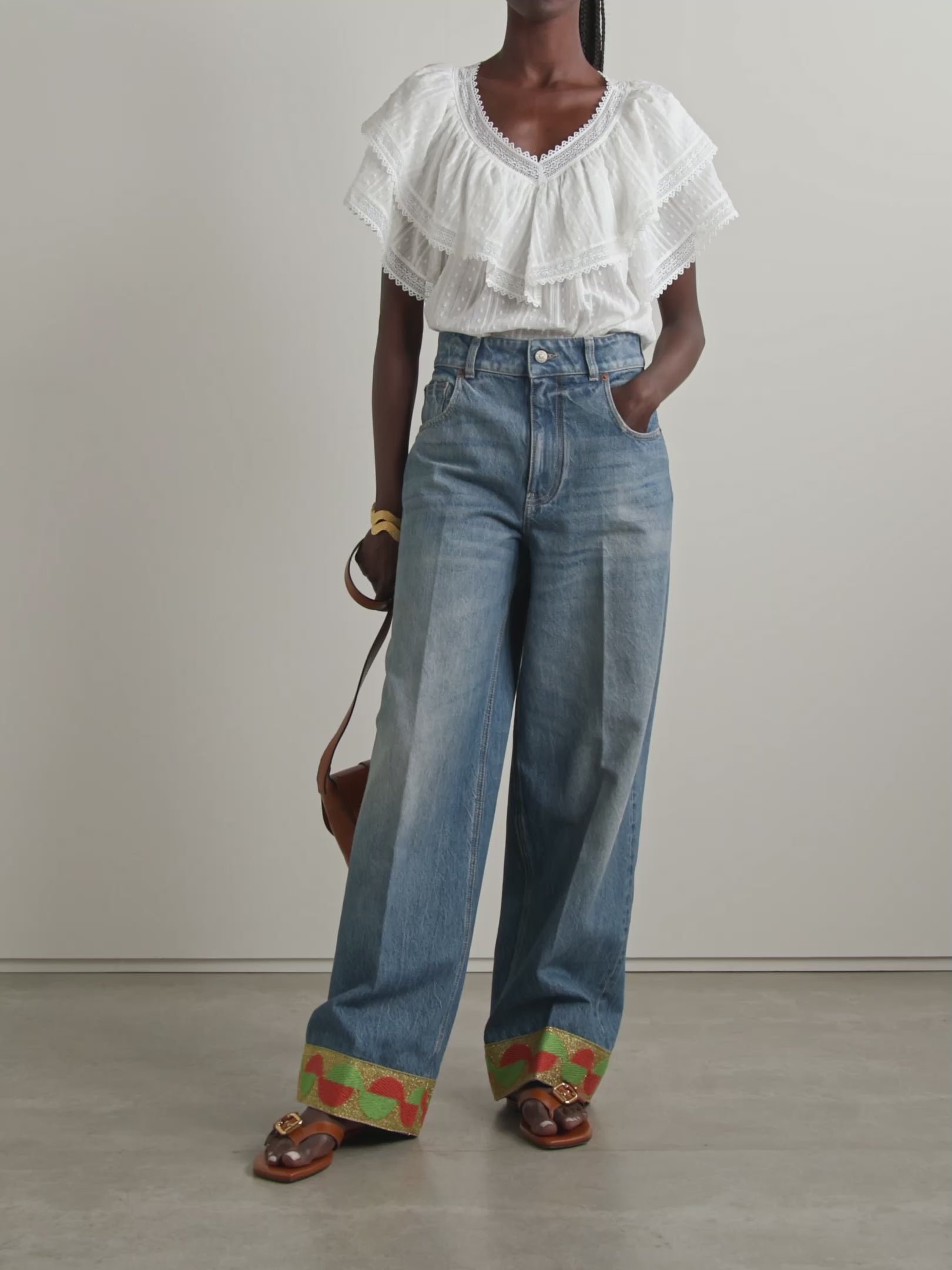 The Cosenza blouse from DÔEN features a delicate fluttery ruffled panel that elegantly highlights the V-neckline and shoulders. Crafted from lightweight fil coupé cotton-voile and accented with airy crochet trims, it offers both comfort and charm. Perfectly versatile, this blouse pairs effortlessly with jeans or flowy skirts, making it a stylish choice for any occasion.